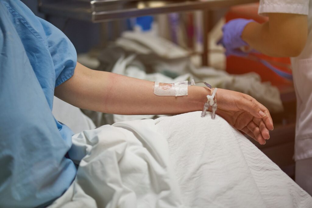 Hospitalized patient with a catheter, highlighting the impact of drug-resistant Acinetobacter baumannii infections in healthcare facilities.