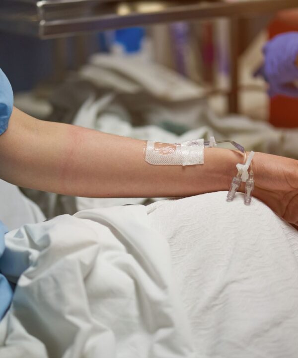 Hospitalized patient with a catheter, highlighting the impact of drug-resistant Acinetobacter baumannii infections in healthcare facilities.