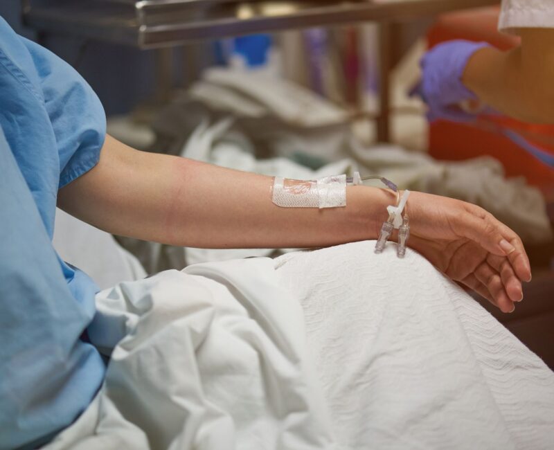 Hospitalized patient with a catheter, highlighting the impact of drug-resistant Acinetobacter baumannii infections in healthcare facilities.