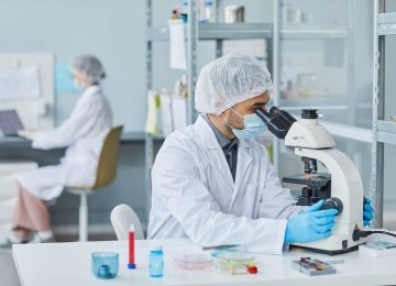 Scientist in a lab working on bacteriophage research, highlighting advanced phage characterization techniques.