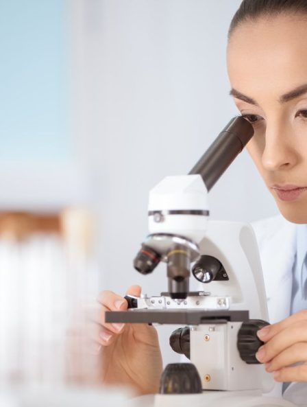 Scientist examining bacteriophages under a microscope, showcasing advanced bacteriophage therapy for targeted bacterial treatment.