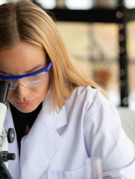 Scientist looking into a microscope, focusing on research involving bacteria and bacteriophage solutions for advanced pathogen control.